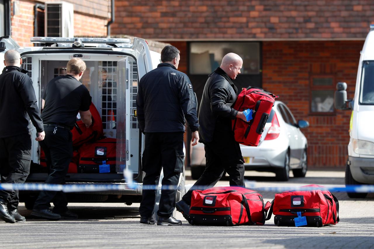 Police officers prepare equipment as inspectors from the Organisation for the Prohibition of Chemical Weapons begin work at the scene of the nerve agent attack on former Russian agent Sergei Skripal, in Salisbury